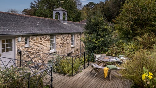 Penrose Stables with its deck and rockery garden with picnic table, Cornwall